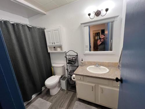 a person taking a picture of a bathroom at Rustic Girdwood Condo in Girdwood