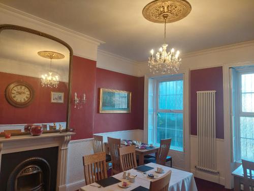 a dining room with a table and a mirror at Parkway Guesthouse in Dublin
