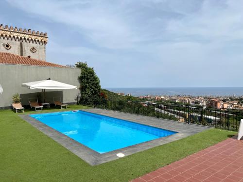a swimming pool in the yard of a house at Villa Leucatia in Sant’Agata Li Battiati 