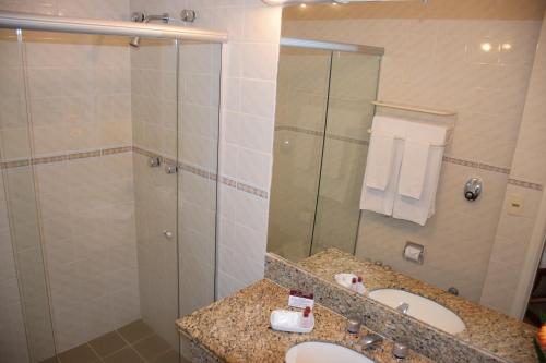 a bathroom with a shower and a sink and a mirror at Augusto's Copacabana Hotel in Rio de Janeiro