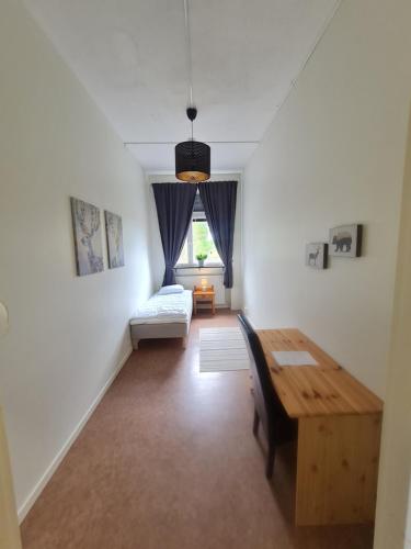 a living room with a table and a couch at Dalasjö vandrarhem in Vilhelmina