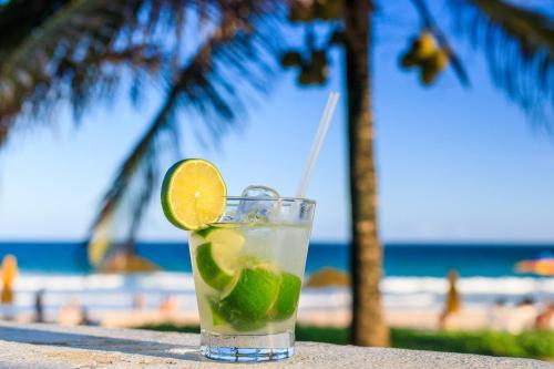 a drink sitting on a table at the beach at Hotel Village Porto De Galinhas in Porto De Galinhas