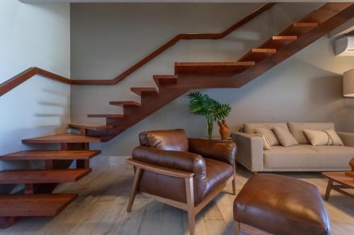 a living room with a staircase and a couch at Serrambi Resort in Porto De Galinhas