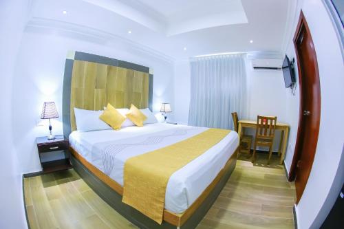 Un ou plusieurs lits dans un hébergement de l'établissement Hotel Vicentina