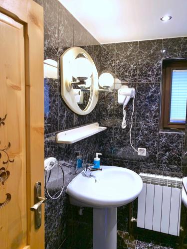 a bathroom with a sink and a mirror at Domek Maria Mąka in Zakopane