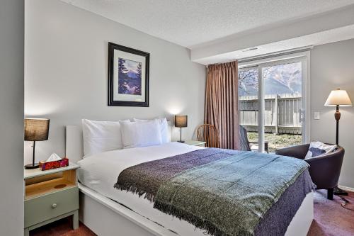 a hotel room with a bed and a window at The Norquay, Pet-Friendly 2 Bed with Mtn View in Canmore