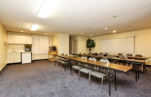 a conference room with a long table and chairs at Red Roof Inn Santa Ana in Santa Ana