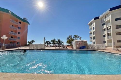 a large swimming pool in front of a building at Beach Cottage 1104 in Clearwater Beach