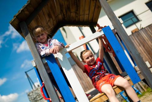 two children playing on a slide at a playground at Dvě Zátoky Kovářov in Kovářov