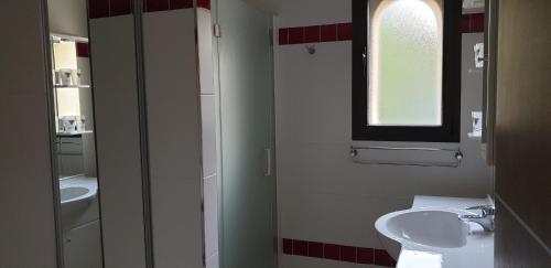 a bathroom with a sink and a toilet and a window at Très bel appartement,proche plage et centre ville. in Calvi