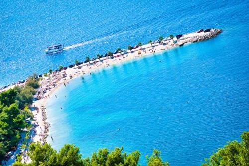 a group of people on a beach in the water at V Luxury Apartment in Split
