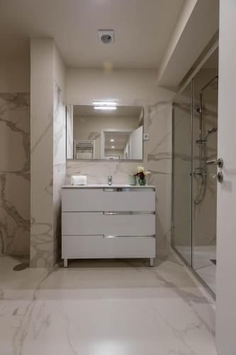 a bathroom with a white dresser and a mirror at Green Apartment Pedras Salgadas in Pedras Salgadas