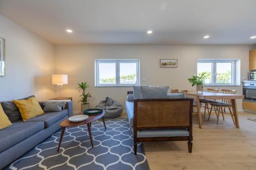 a living room with a couch and a table at Green Apartment Pedras Salgadas in Pedras Salgadas