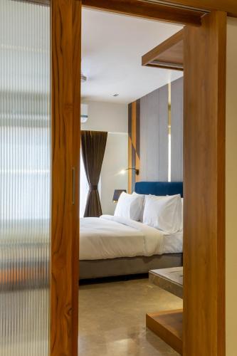 a bedroom with a large bed and a window at Hotel Nalanda in Ahmedabad