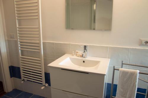 a bathroom with a white sink and a mirror at Skylight Sorrento in Sant'Agnello