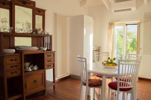 a dining room with a white table and chairs at Skylight Sorrento in Sant'Agnello