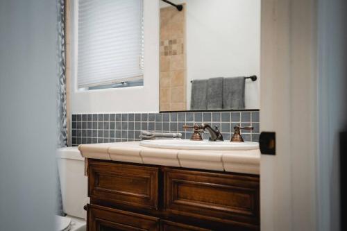 a bathroom with a sink and a toilet and a mirror at The San Diego Studio - Free Parking in San Diego