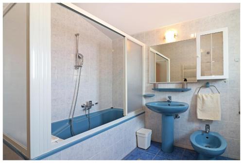 a bathroom with a blue sink and a shower at Kuća za odmor Angelina in Primošten