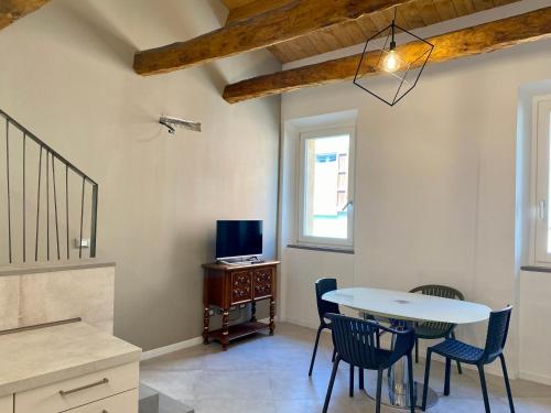 a dining room with a table and chairs and a tv at Residence La MARCHINA in Castel Bolognese