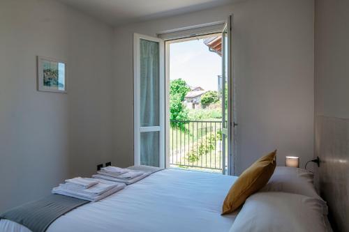 a bedroom with a bed with a large window at The view apartment 2 in Bellagio