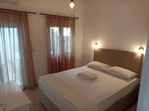 a bedroom with a bed with two towels on it at Marina Villa in Kokkini Khanion