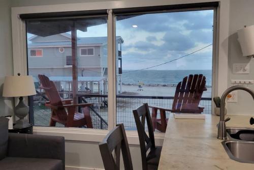 a kitchen with a large window with a view of the ocean at Las Casitas on Magnolia Beach - Casita B in Port Lavaca