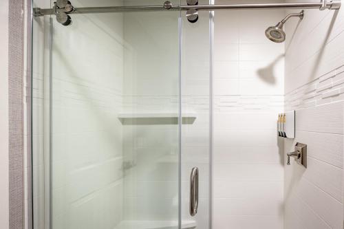 a shower with a glass door in a bathroom at Best Western Plus Stevenson Manor in Calistoga