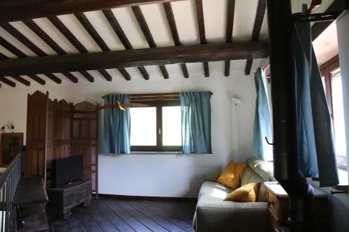 a living room with a couch and a window at Casa La Gorga in Cagli
