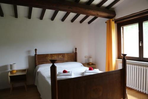 a bedroom with a bed with two towels on it at Casa La Gorga in Cagli