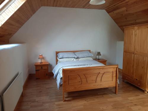 a bedroom with a bed and two night stands at Traditional Cosy Cottage with beautiful views in Westport