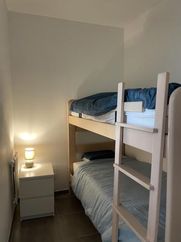 a bedroom with a bunk bed and a small room with a bed at Middelbeach in Middelkerke