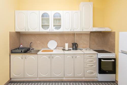 a kitchen with white cabinets and a sink at Apartments Kiki in Kotor