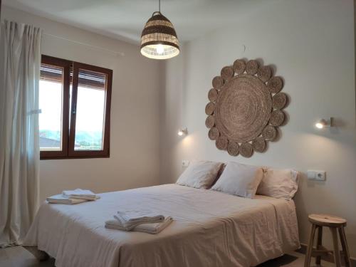 a bedroom with a bed with a mirror on the wall at Villa Thálassa in Benicarló