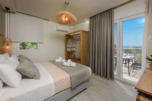 a bedroom with a large bed and a balcony at Alfa Boutique in Kinira