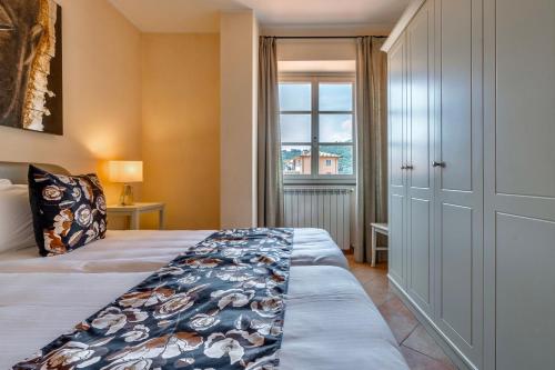a bedroom with a bed and a window at Baba Residences in Alassio
