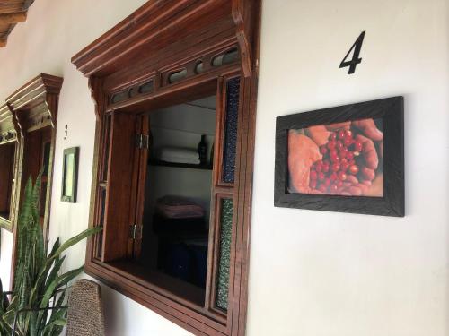 a mirror with a picture of grapes on a wall at Finca Hotel Brasilia in La Tebaida