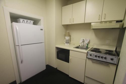 uma cozinha com armários brancos e um frigorífico branco em Boardwalk Beach Resort em Myrtle Beach