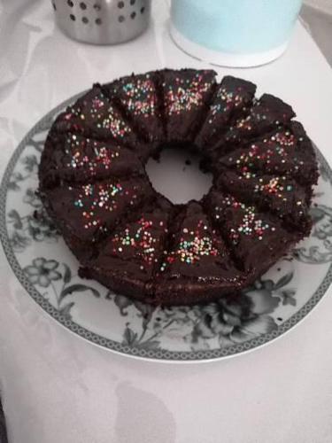 a chocolate cake with sprinkles on a plate on a table at Daniela in Policastro Bussentino