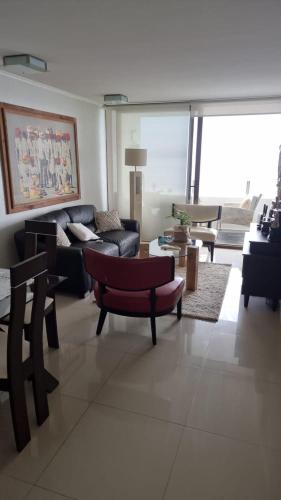 a living room with a couch and a table at Jardin Del Mar, Av del Mar in Coquimbo