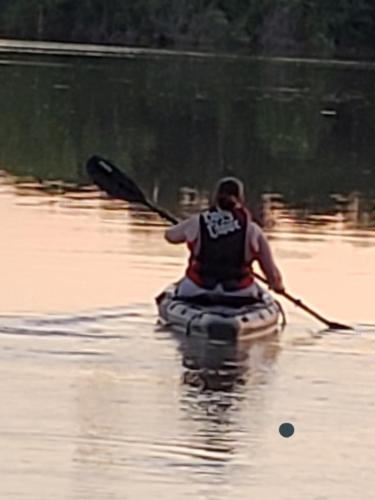 a person in a kayak on a body of water at Lake Front cottage in Little Elm