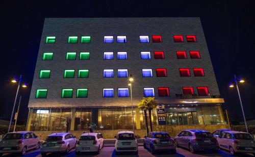a building with cars parked in front of it at night at Best Western Hotel Goldenmile Milan in Trezzano sul Naviglio