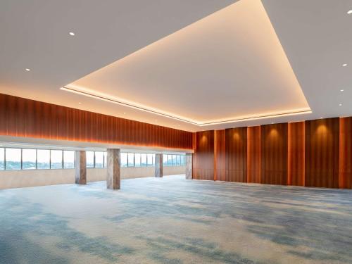 a large room with wooden walls and a large ceiling at Radisson Lampung Kedaton in Bandar Lampung