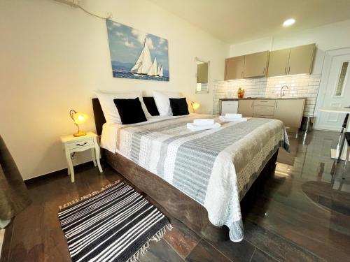 a bedroom with a large bed with a sailboat on it at Apartments Sunset in Mlini