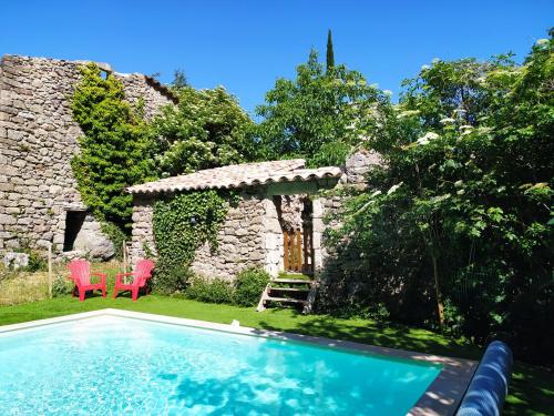 une maison avec une piscine dans une cour dans l'établissement Les Châtaigniers Gîtes du Mas Haut, à Saint-Jean-du-Gard