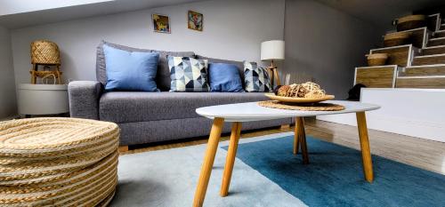 a living room with a couch and a table at Mía Suites I Centro Histórico - PARKING & WIFI FREE in Burgos