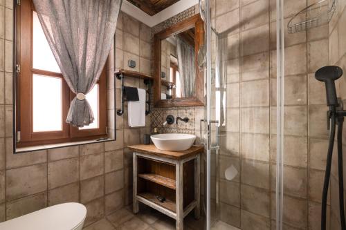 a bathroom with a sink and a shower at Ey Sofias Suites in Rhodes Town