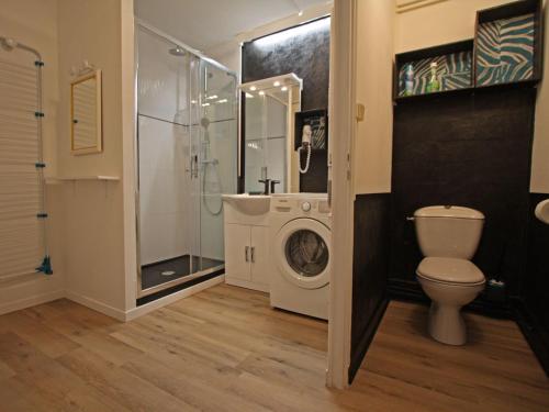 a bathroom with a washing machine and a toilet at Gîte Plombières-les-Bains, 2 pièces, 2 personnes - FR-1-589-289 in Plombières-les-Bains
