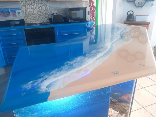a counter with a fish tank in a kitchen at Beach Splendor @ 24 La Crete Sands in Margate
