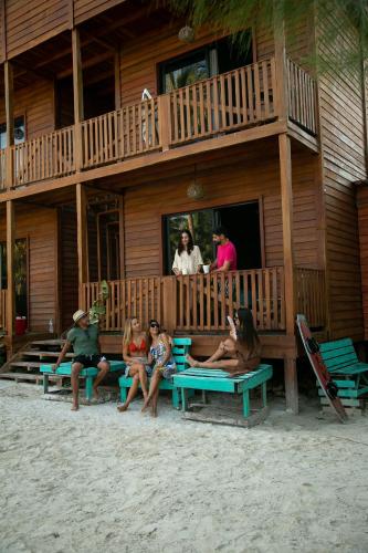 a group of people sitting on benches on the beach at El Regalo El Cuyo in El Cuyo