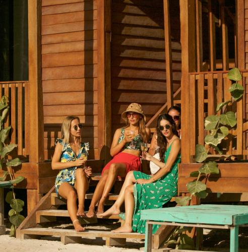 a group of women sitting on the steps of a house at El Regalo El Cuyo in El Cuyo